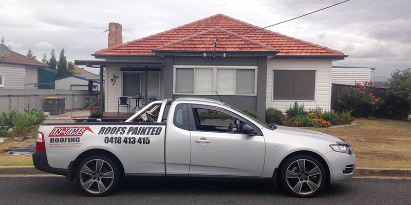 In-Time Roofing ute in front of a house - roof restoration, NSW