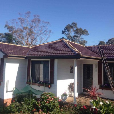Roof Painted in Maroon— roof restoration newcastle